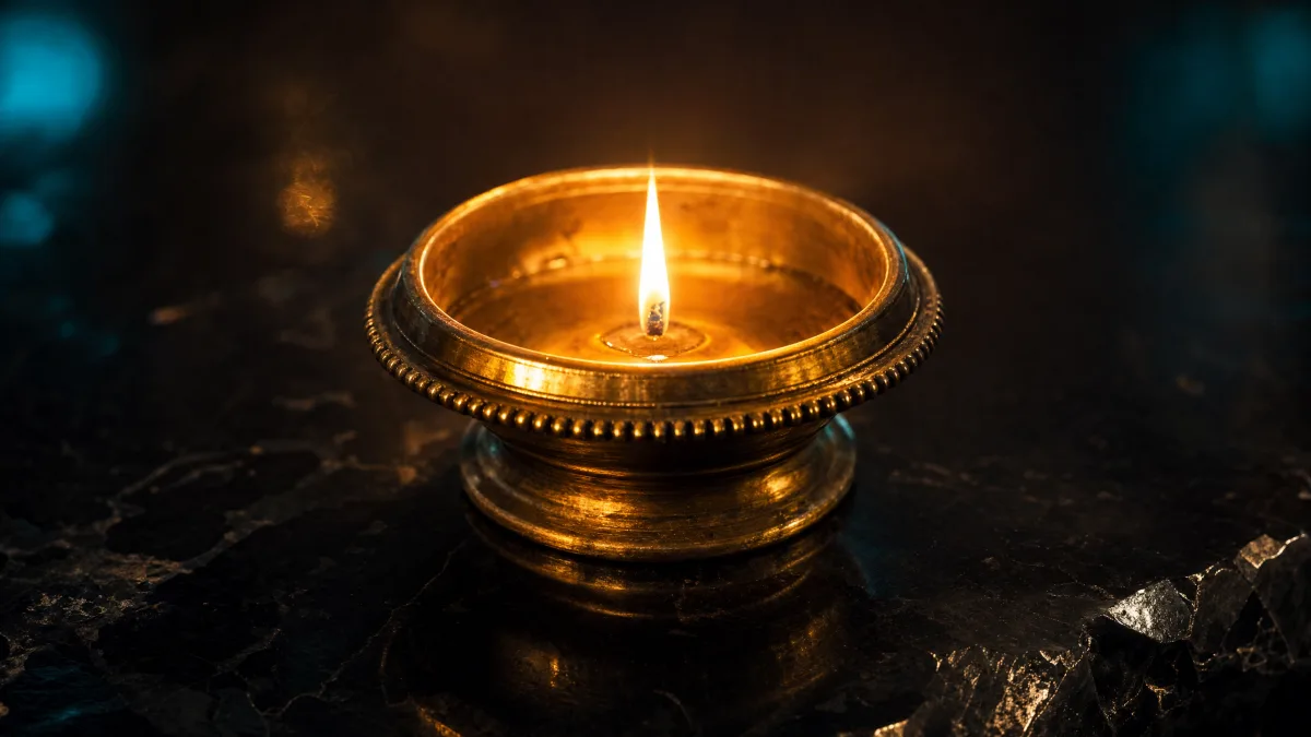 A single steady flame in an open brass vessel resting on polished black obsidian